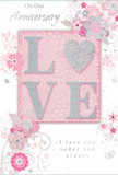 Captured in gentle, flattering light, this anniversary card blends pastel pinks and silvery greys into a design that feels as intimate and treasured as a quiet evening stroll through Berrylands. At the centre, the word LOVE is spelled out in raised, soft glitter, the letters rounded and inviting, with the O replaced by a shimmering silver heart. That heart, textured and slightly embossed, glows against the blush background, echoing the gleam of polished vase glass on a windowsill. Around this focal point, delicate blossoms in blush and muted mauve seem to unfurl in slow motion, their edges softened as if painted in watercolour. Fine, flowing lines sketch slender stems and gentle curls of foliage, while tiny flourishes - scattered petals, graceful swirls, and subtle butterfly outlines - add playful movement, like petals caught in a light breeze along a Berrylands garden path. The background is a soft wash of pink and light grey, understated yet warm, creating a cocoon of calm romance. Across the design, in refined, flowing script, are the words On Our Anniversary and I love you today and always, the lettering poised and elegant without feeling formal. Together, the tactile glitter, the floral illustrations, and the thoughtful typography create a composition that feels like a keepsake from a trusted Berrylands florist, ideal for honouring the shared journey of two people who appreciate both beauty and quiet sincerity in their celebration of love.